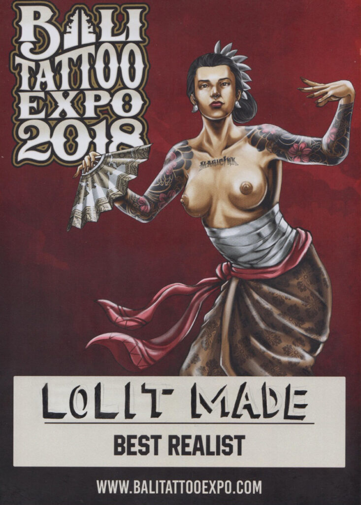 An ornate certificate awarded to a Bali tattoo artist, featuring traditional Balinese patterns and motifs. The certificate is in a wooden frame, with the artist's name boldly written, recognizing them as a "Master of Ink" for their exceptional skills and contributions to the art of tattooing in Bali.