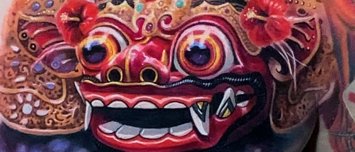 An image from a portfolio showing an award-winning artist in Bali as they work on a detailed sleeve design. The photo emphasizes the skill and dedication of Balinese tattoo artists, making it a sought-after destination for tattoo enthusiasts.