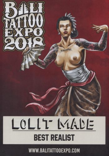 An ornate certificate awarded to a Bali tattoo artist, featuring traditional Balinese patterns and motifs. The certificate is in a wooden frame, with the artist's name boldly written, recognizing them as a "Master of Ink" for their exceptional skills and contributions to the art of tattooing in Bali.