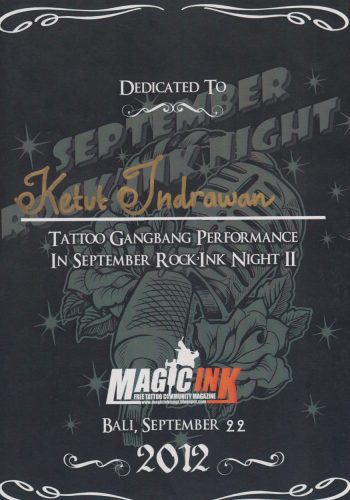 A prestigious award certificate displayed on a teakwood desk, with intricate carvings and a golden seal. It is presented to a tattoo artist of Hispanic descent in Bali, celebrating their innovative designs and dedication to maintaining the cultural integrity of traditional Balinese tattoo art.